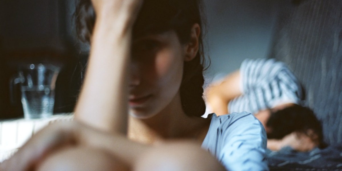 The Downward Spiral Of Being In An Abusive Relationship woman hiding herself from man