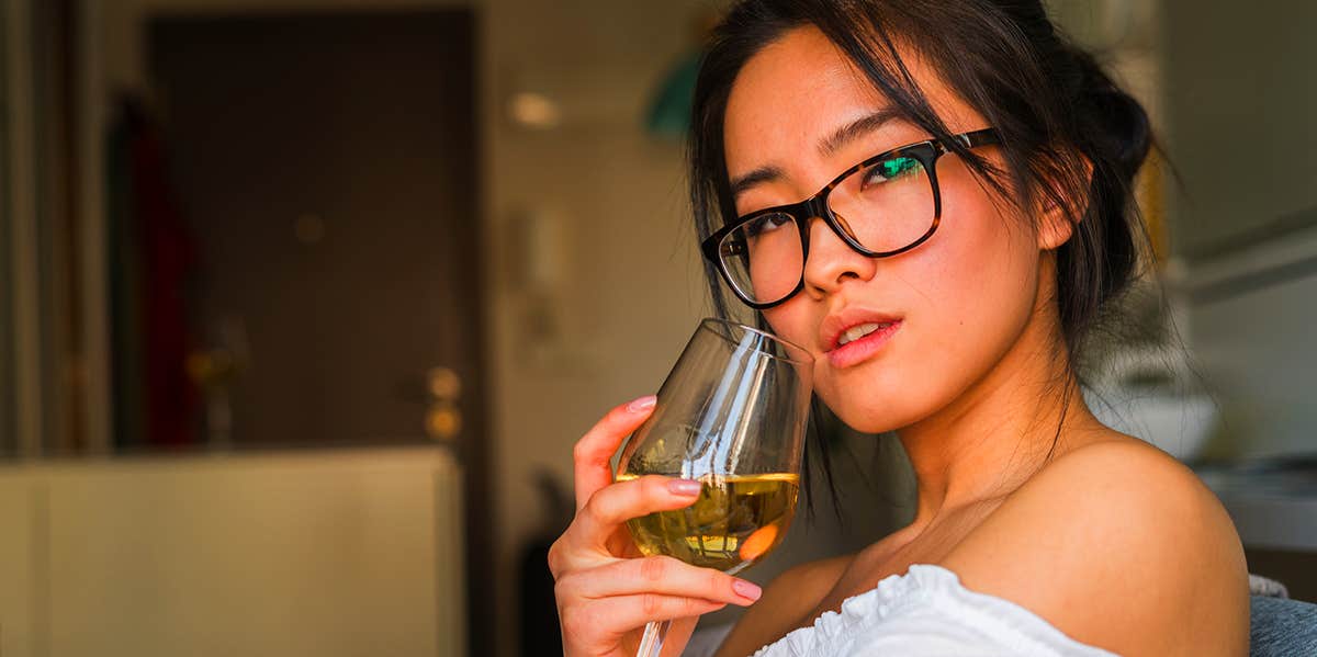 woman drinking wine on couch