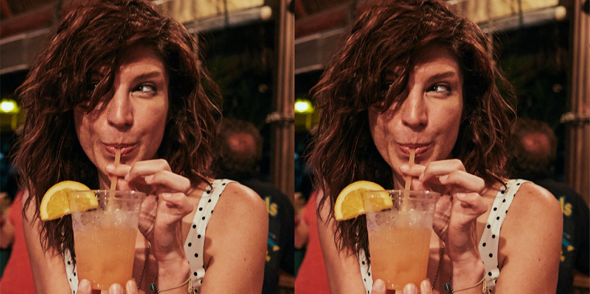 woman sipping drink out straw