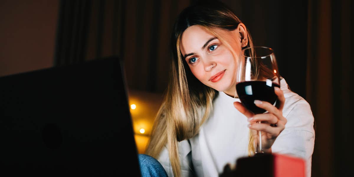 woman looking at laptop at night