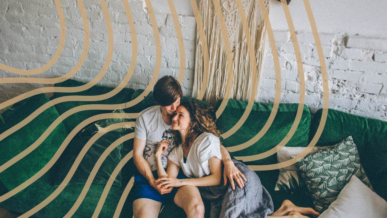 Happy couple snuggling on the couch