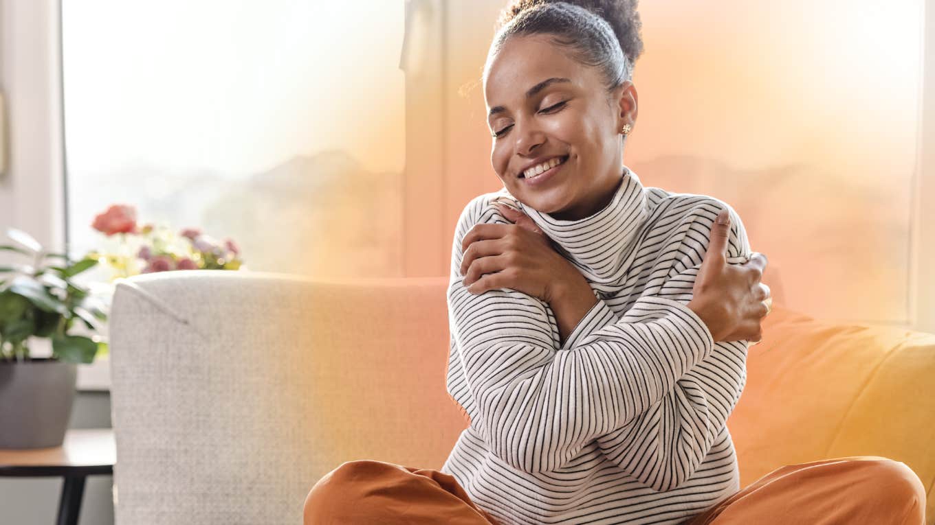 Woman accepting and hugging herself