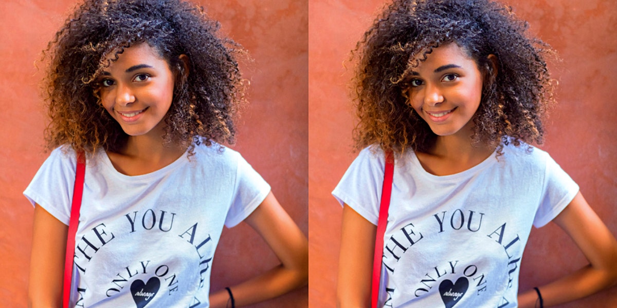 Why Your Ego Is Helpful In Living Your Best Life (Sometimes) young Black woman smiles at the camera on an orange background