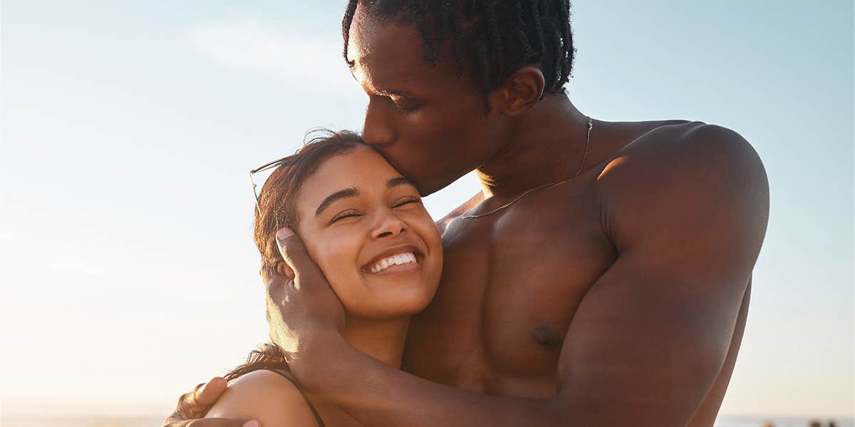 guy kissing girl's head