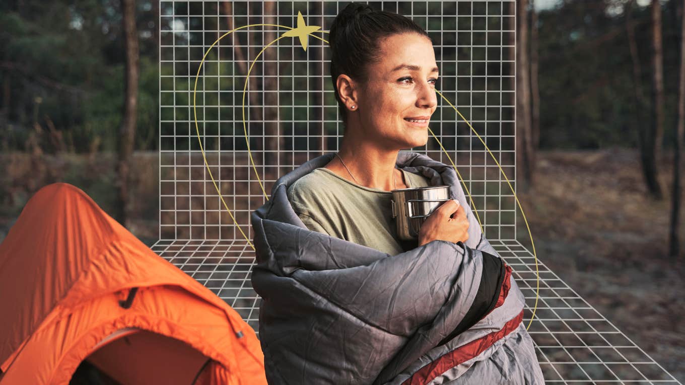 Woman standing outside her tent embracing the early morning air 