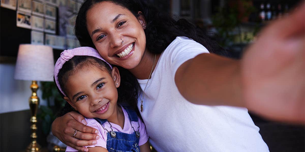 mom taking selfie with daughter