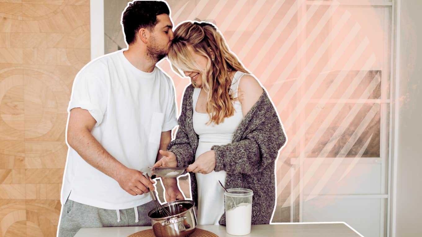 Couple cooking together, kissing in kitchen 