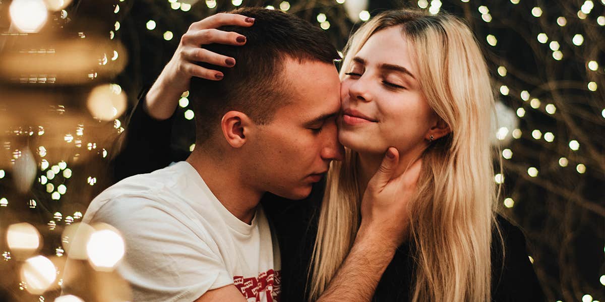 woman grasping top of man's head