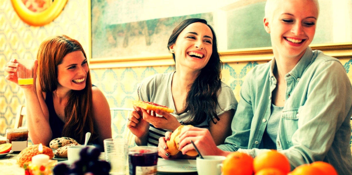 three happy women eating