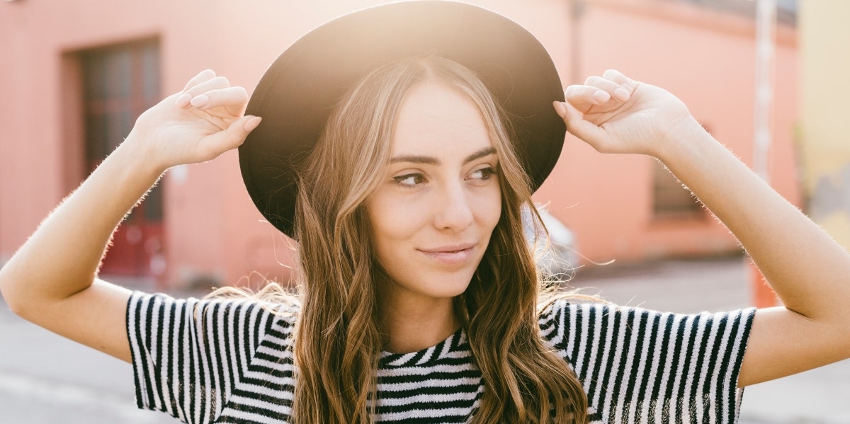 smiling woman wearing a hat