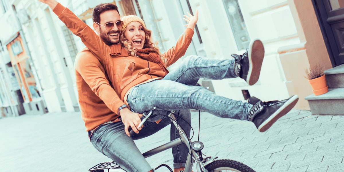 couple on bike together having fun