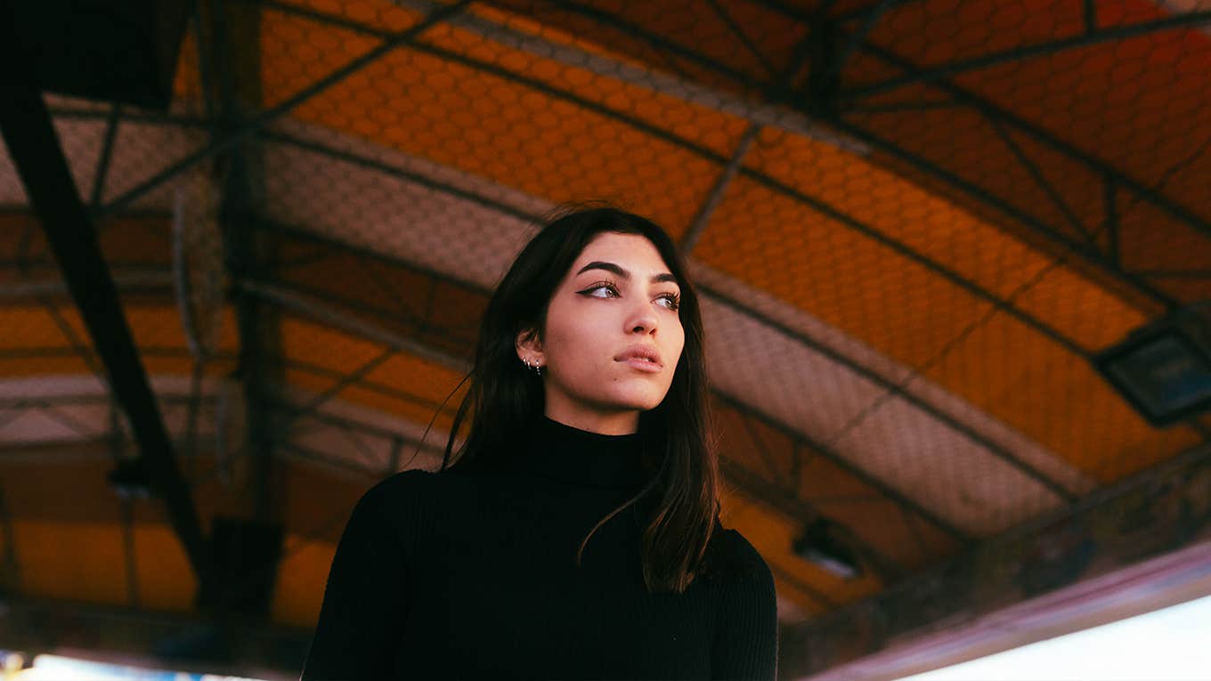 young brunette woman with a dark yellow background