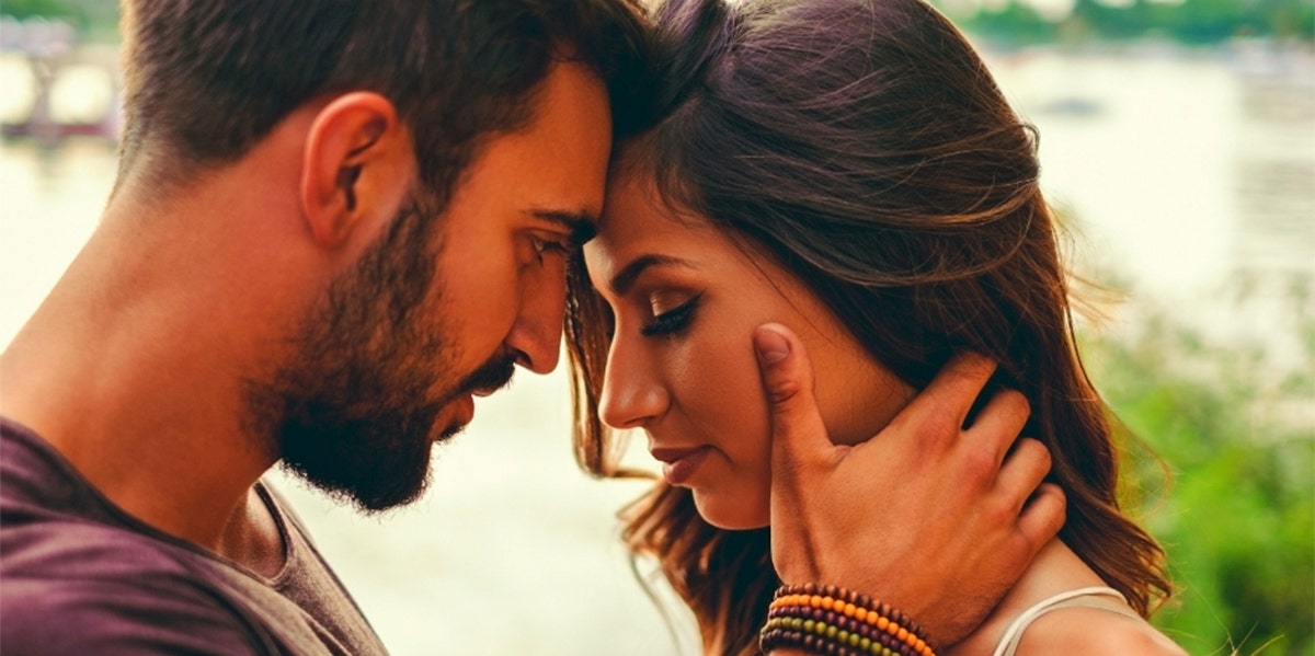 Couple pressing foreheads together emotionally