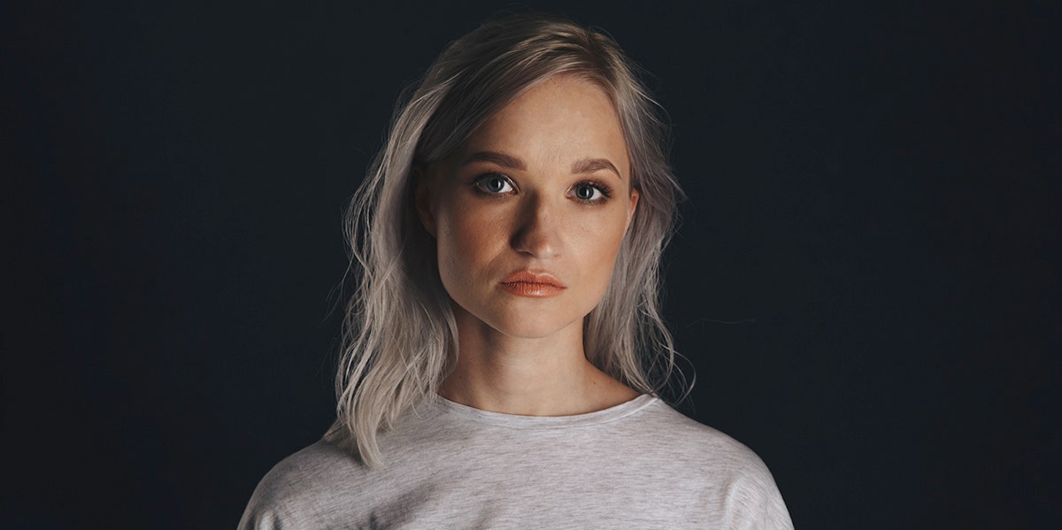 blonde woman on black background