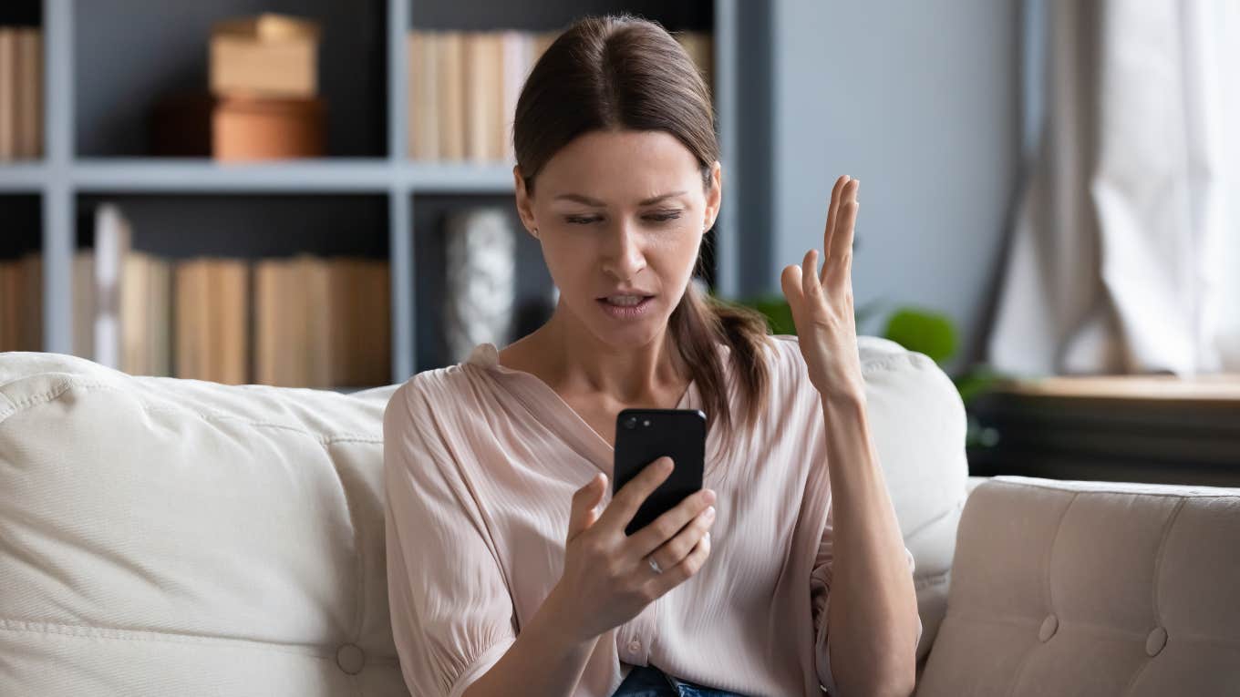 angry woman looking at phone