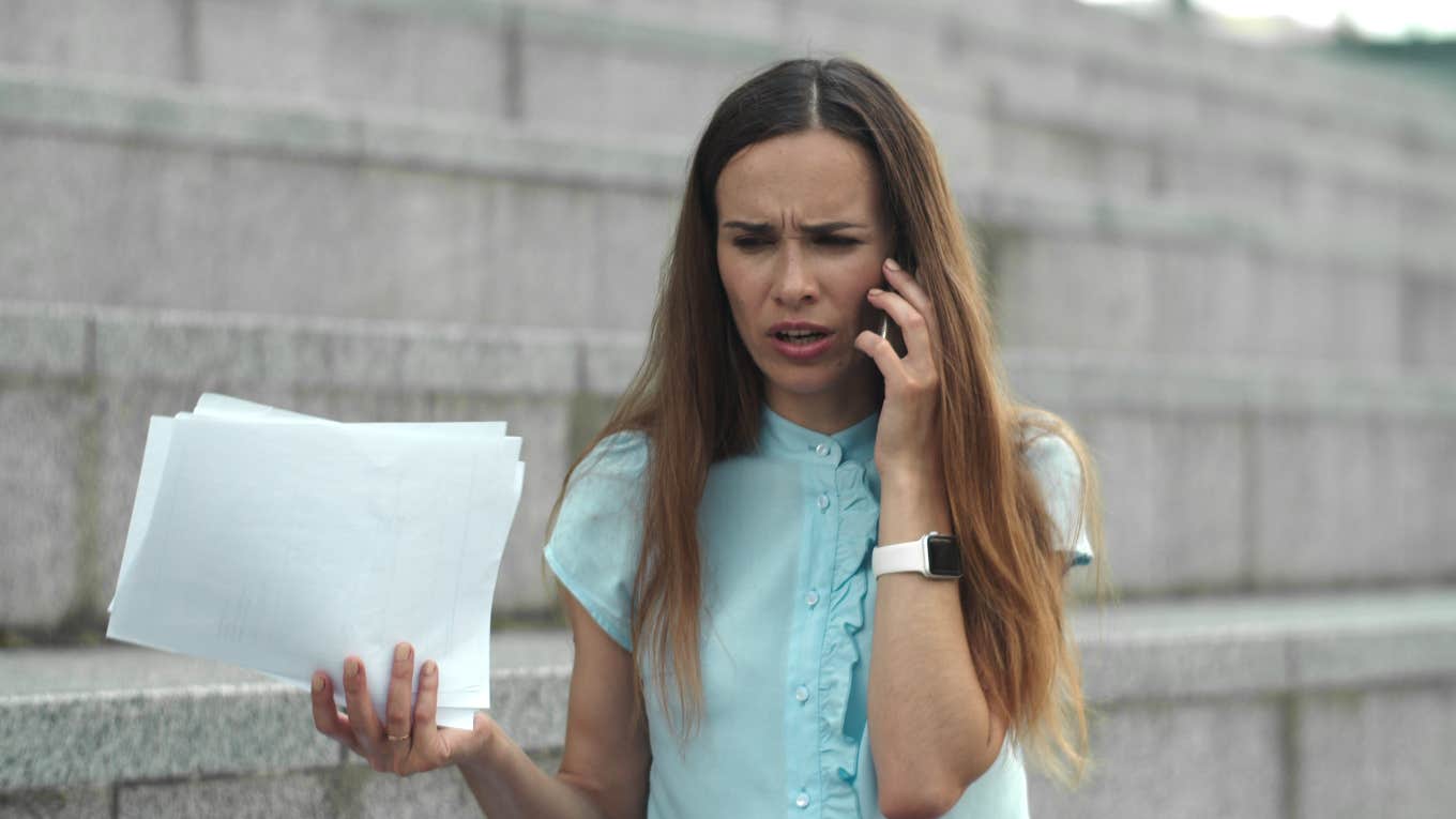 upset businesswoman talking on the phone