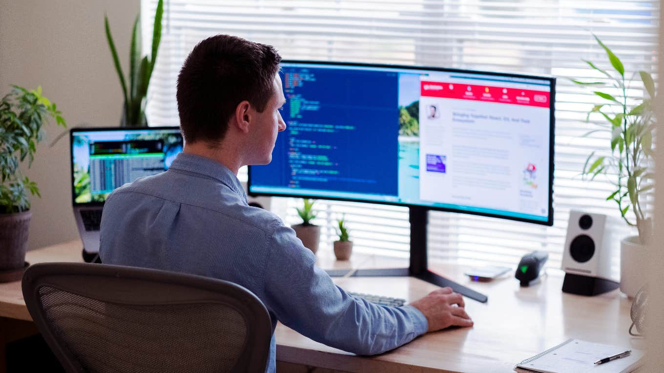 'Overemployed' Man Fired For Using 'Mouse Jiggler' To Work Multiple Jobs At Once man working on computers