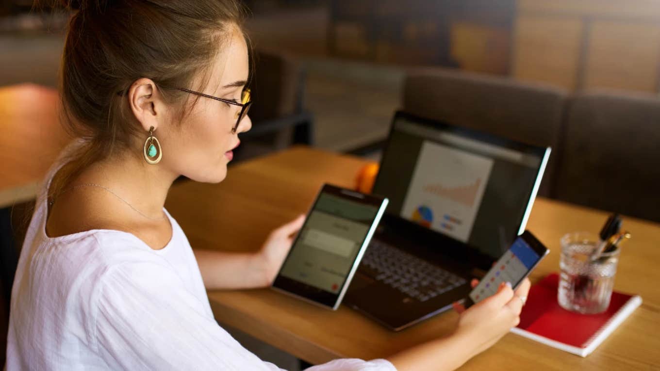 woman working on laptop, tablet and phone