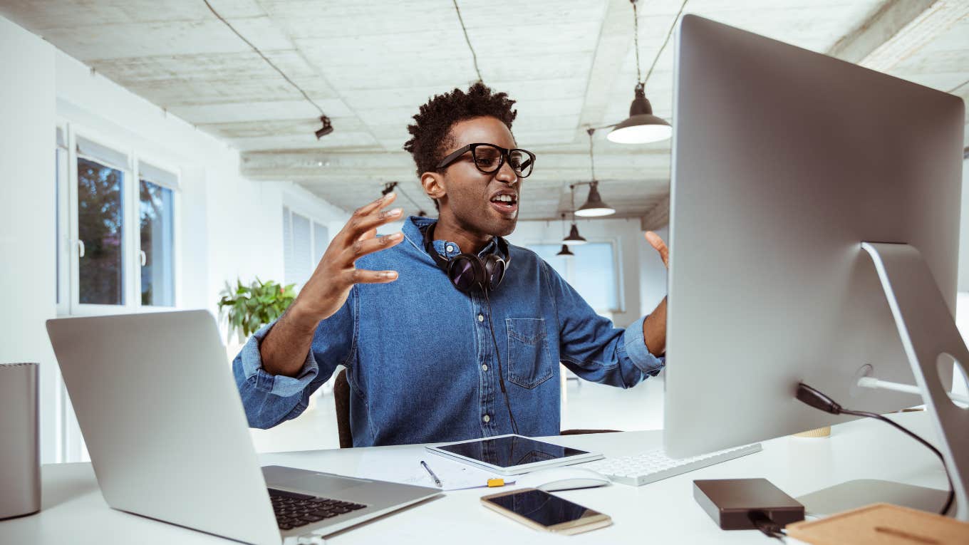 Man looking frustrated while staring at computer. 