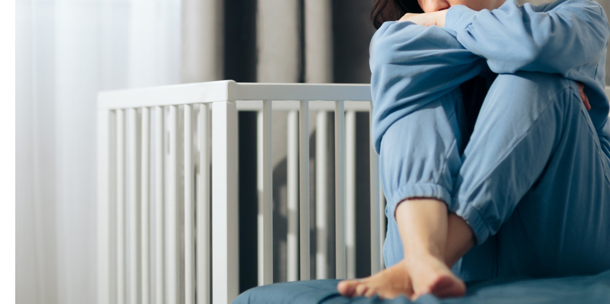 Mother with empty crib