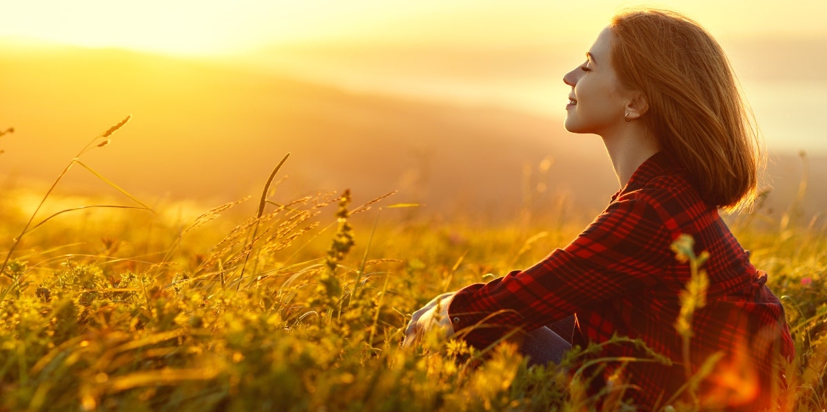 relaxed woman sitting on the field