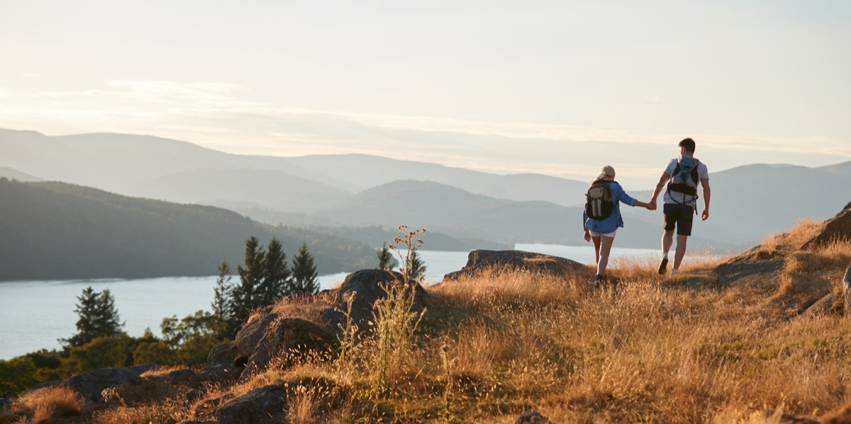 couple walking on hill together