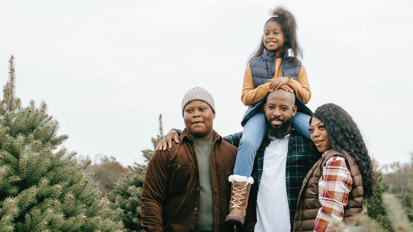 family with christmas trees