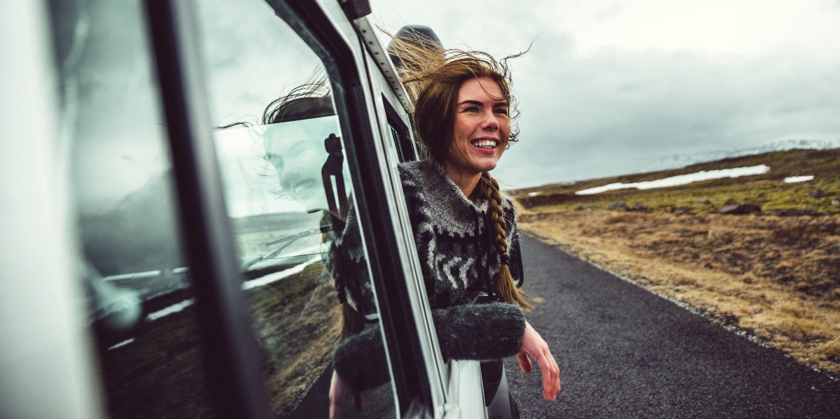enneagram type nine happy woman in the car