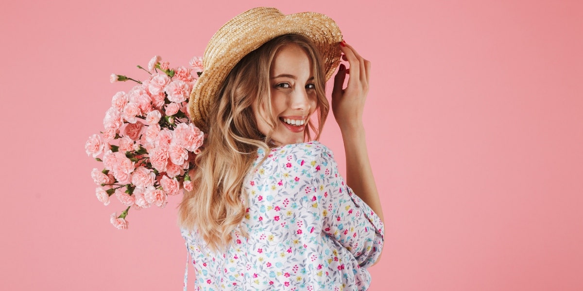 smiling woman holding flowers