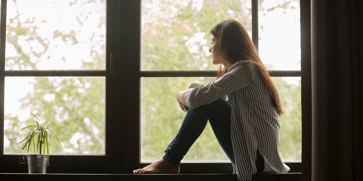 woman looking out window