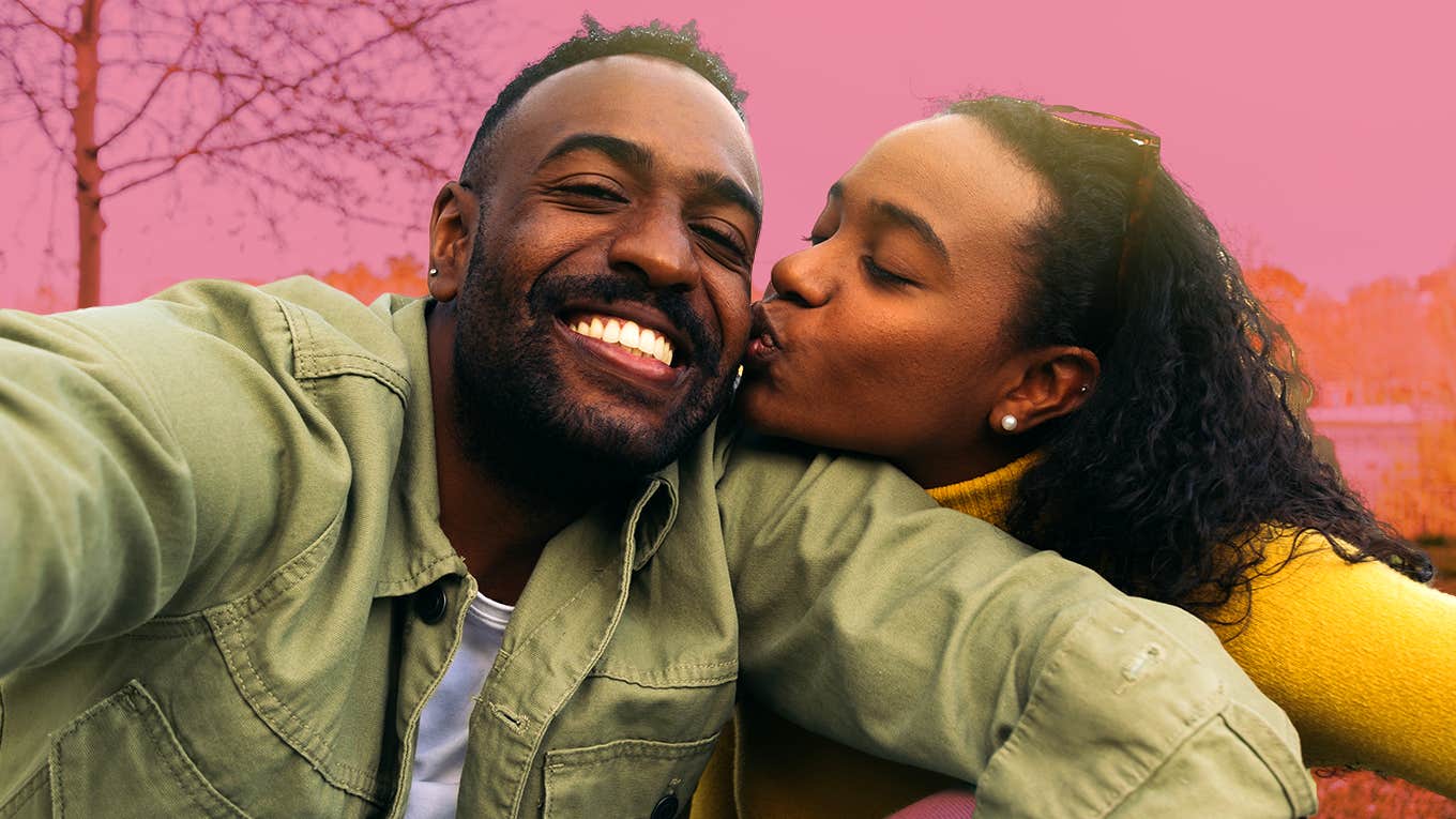 7 Tiny-But-Effective Ways To Start A Relationship Off Right woman kissing man's cheek while taking selfie
