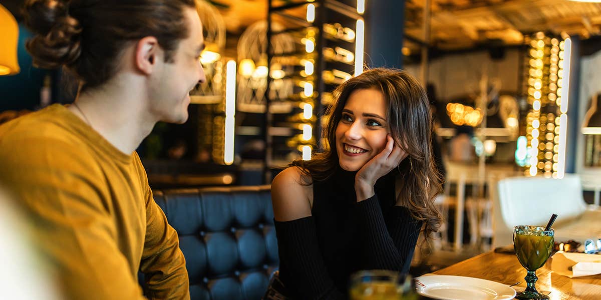 Experts Reveal The Harsh Reasons Men Might 'Disappear' After A Third Date couple chatting on dinner date