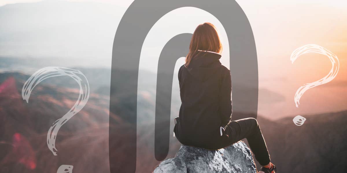 Woman sitting high on rock