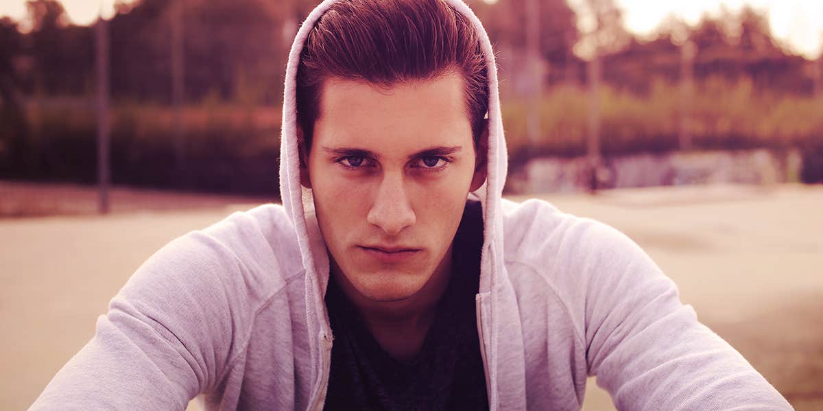 Fixable Personality Traits Women See As Red Flags, According To Experts man wearing jacket with hood up