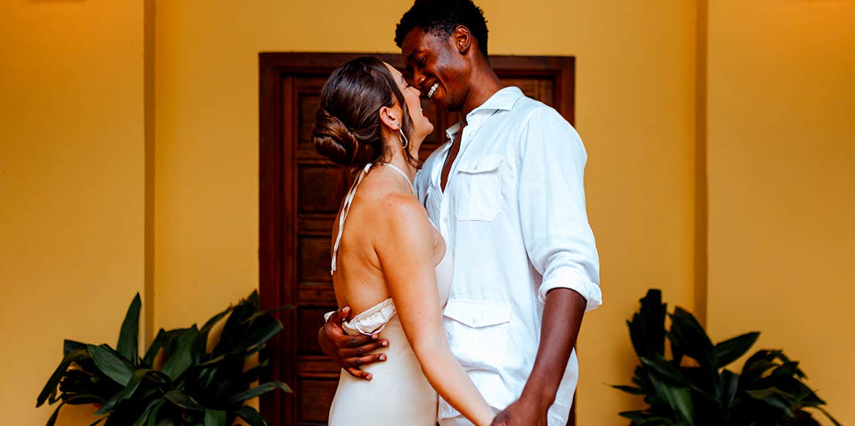 smiling couple standing on porch together