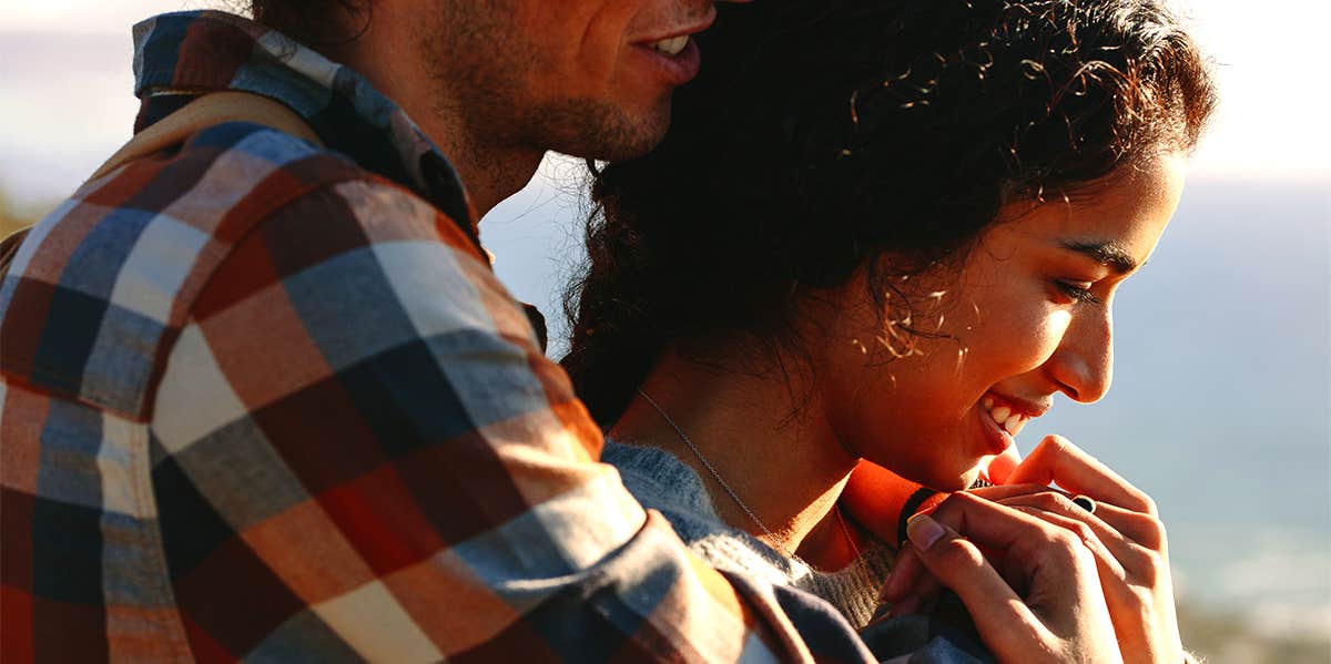 man hugging woman from behind