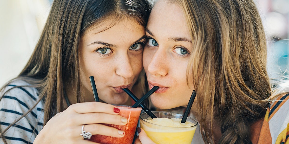 two women sipping drinks