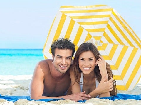 couple under umbrella on beach