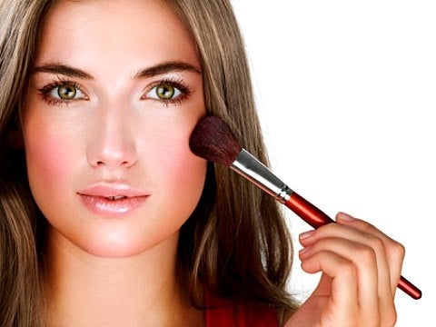 New Year's Eve makeup woman applying blush