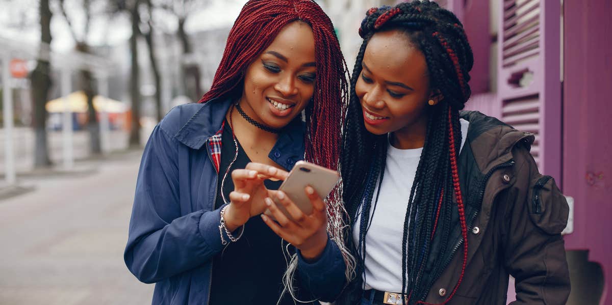 2 women looking at phone