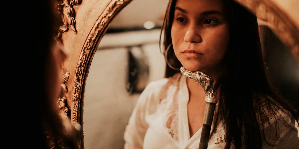 woman looking in mirror