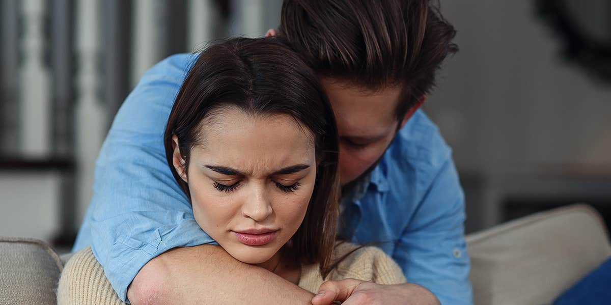 man hugging wife from behind