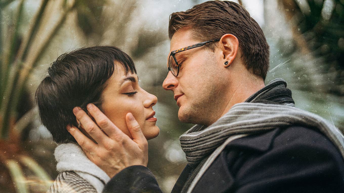 man holding woman close embracing