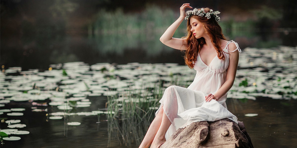 woman sitting by lilypads