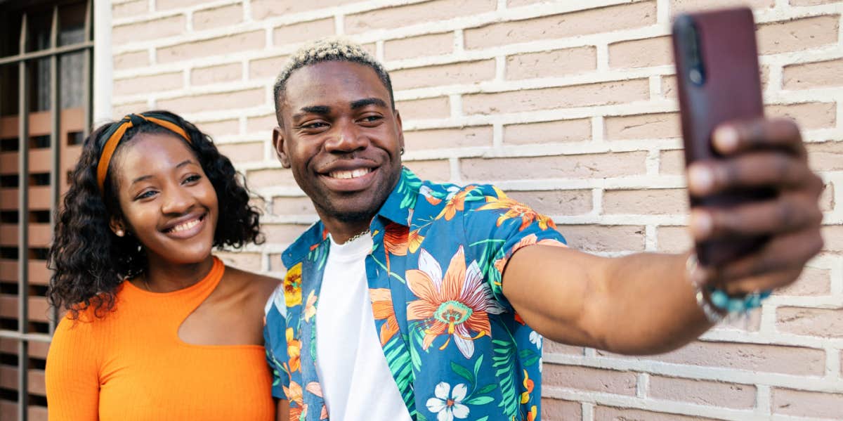 smiling couple taking selfie together