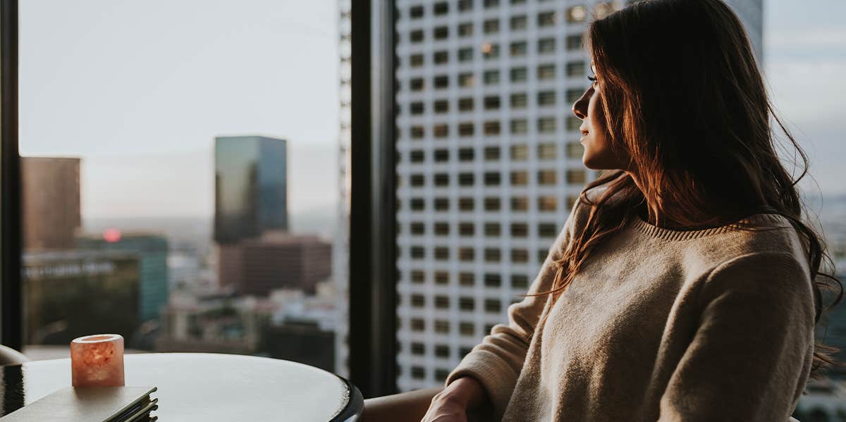 woman looking out a window