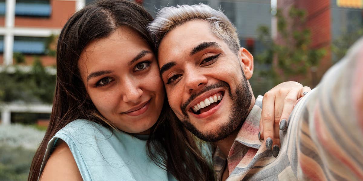 man and woman taking selfie