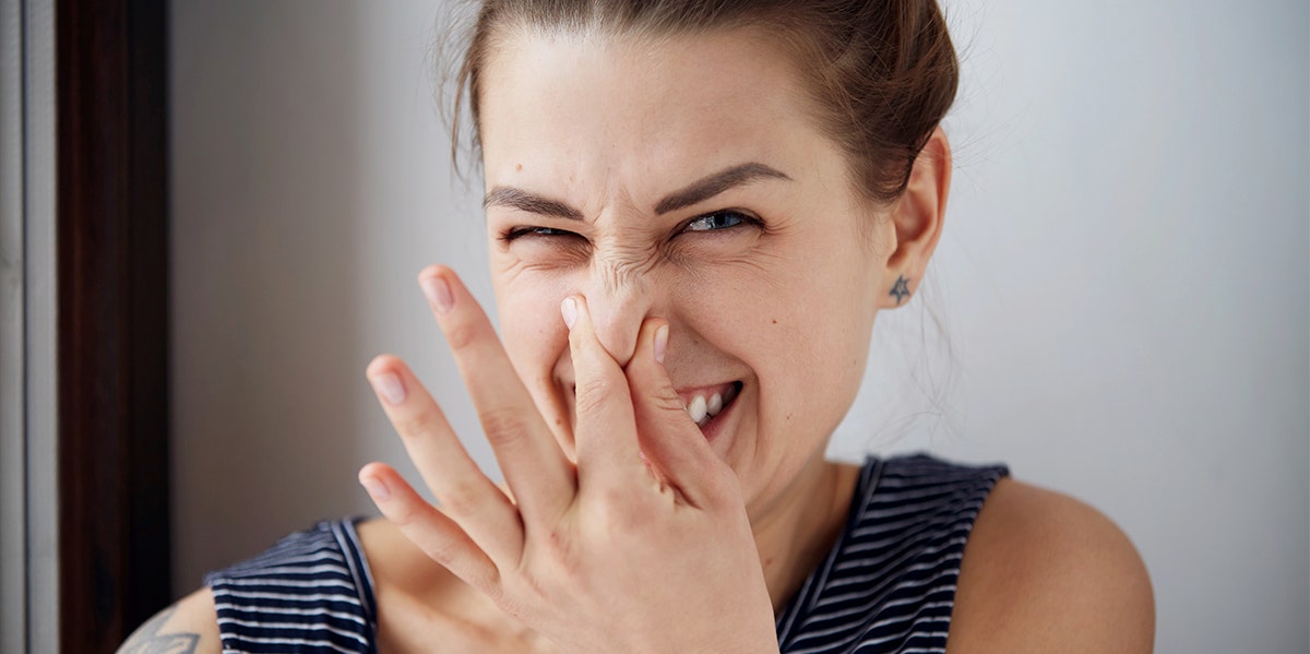 woman covering nose