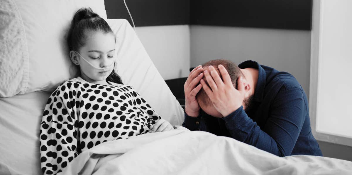 sad father leaning on sick daughter's hospital bed