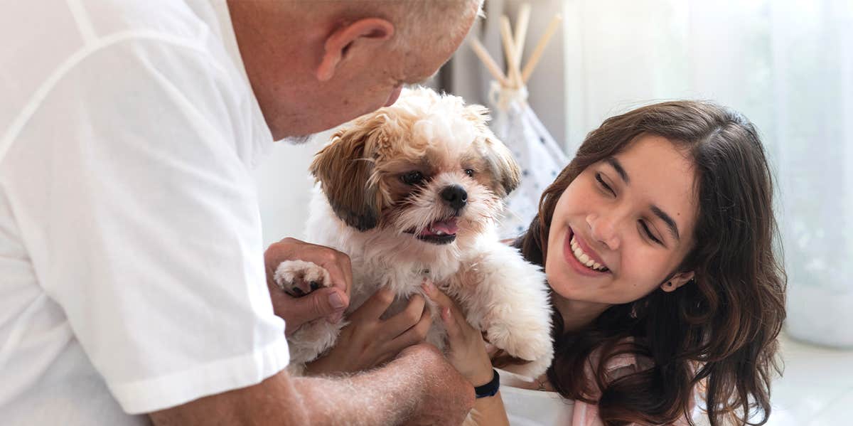 dad and daughter holding puppy